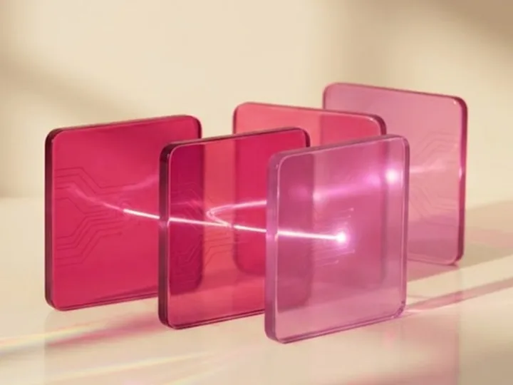 Pink glass panels with a beam of light passing through them